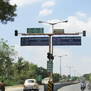 Kovai Medical Center Signal Board on Highway with Traffic and Trees
