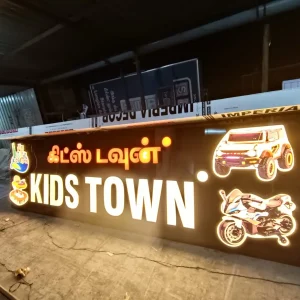 Illuminated 'Kids Town' name board with toy car and bike graphics