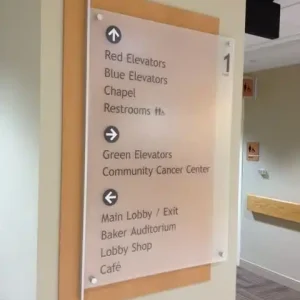 Wayfinding signage for elevators, restrooms, chapel, cancer center, and lobby at building
