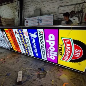 Custom Sticker Cutting Backlit Board featuring tyre brand logos with LED illumination