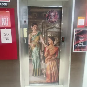 Lift Door Branding with Two Women in Traditional Sarees